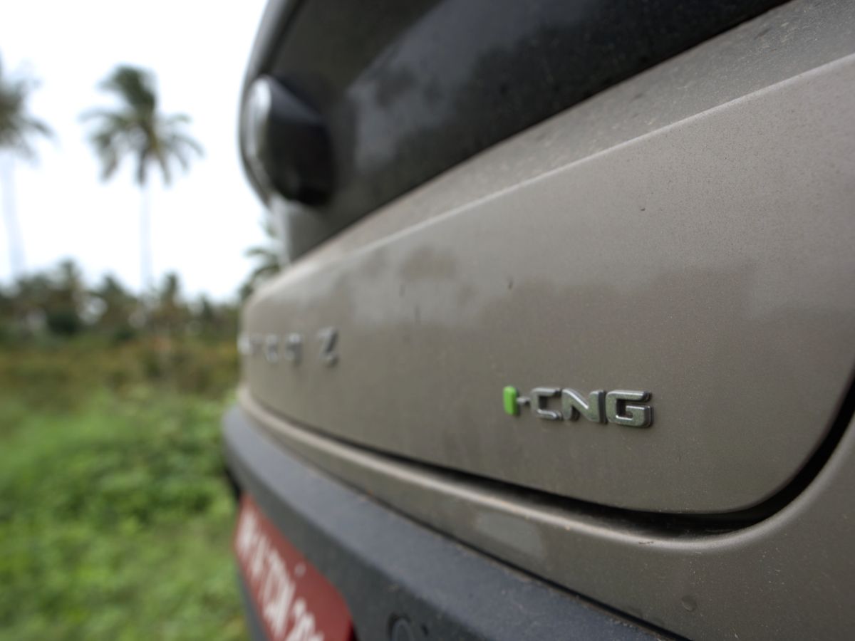 2025 tata altroz cng review facelift rear boot lid shot rain car photography aryan